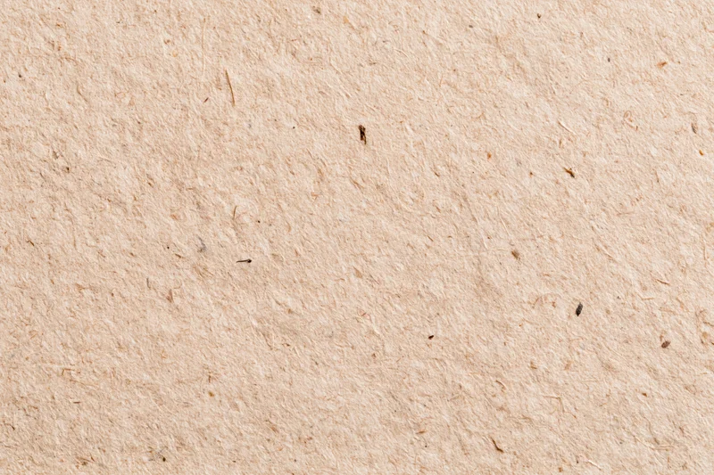 Close-up flat lay of recycled kraft paper surface filling the frame
