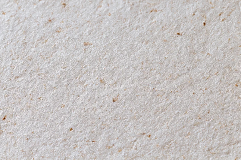 Close-up flat lay of recycled kraft paper surface filling the frame