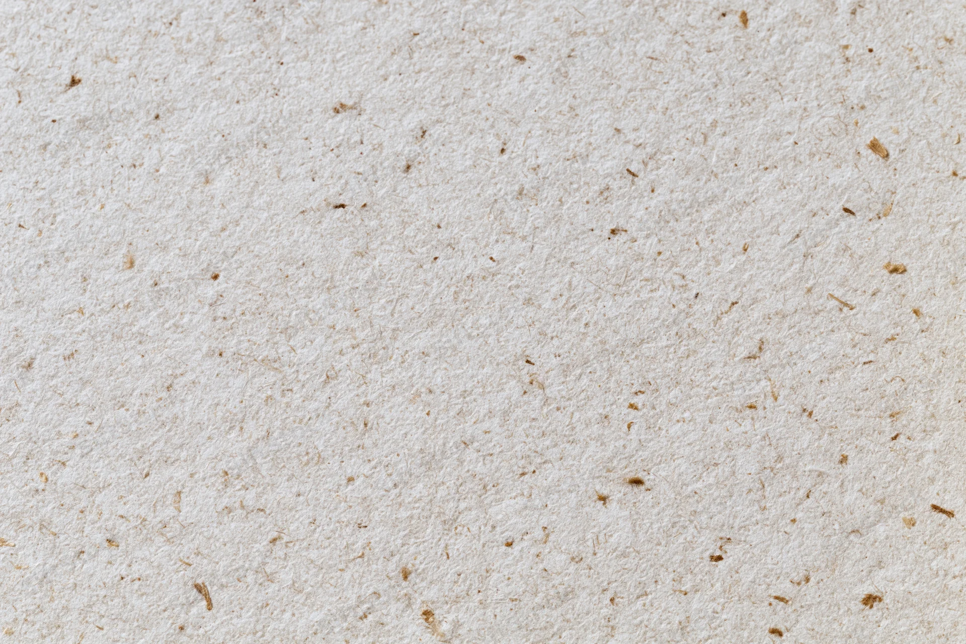 Close-up flat lay of recycled kraft paper surface filling the frame