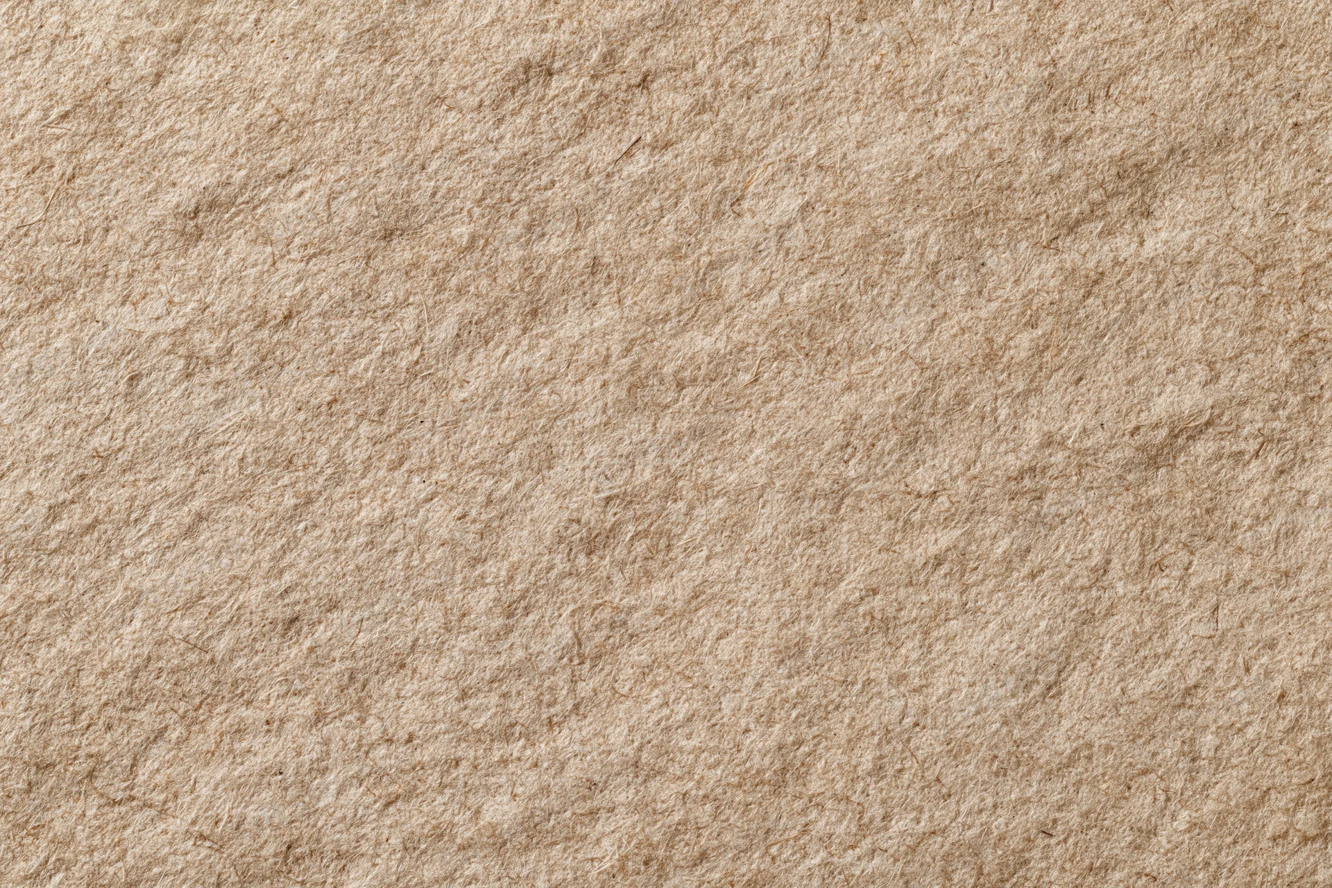 Close-up flat lay of recycled kraft paper surface filling the frame