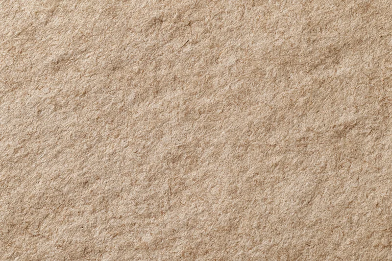 Close-up flat lay of recycled kraft paper surface filling the frame