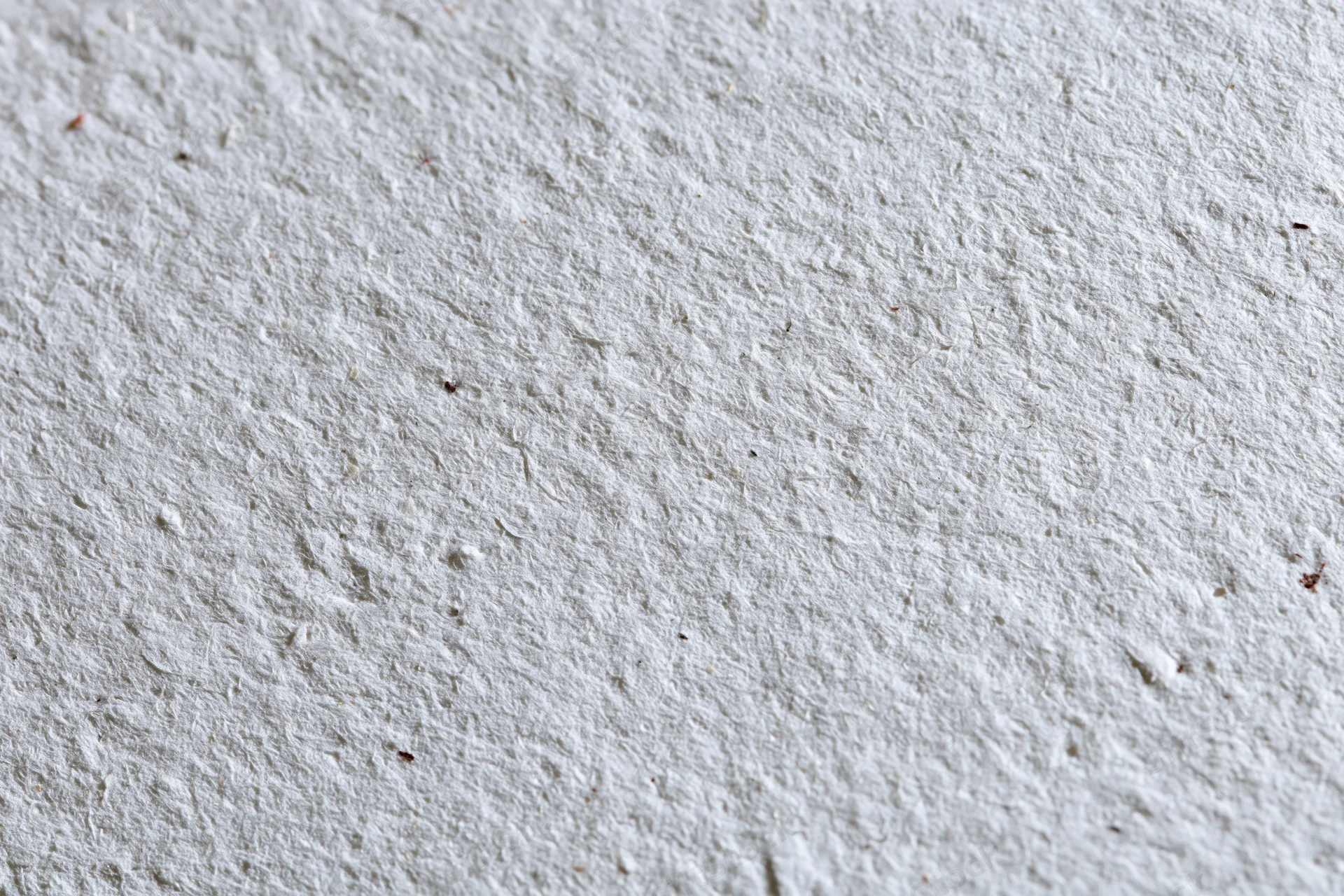 Close-up flat lay of recycled white paper surface filling the frame