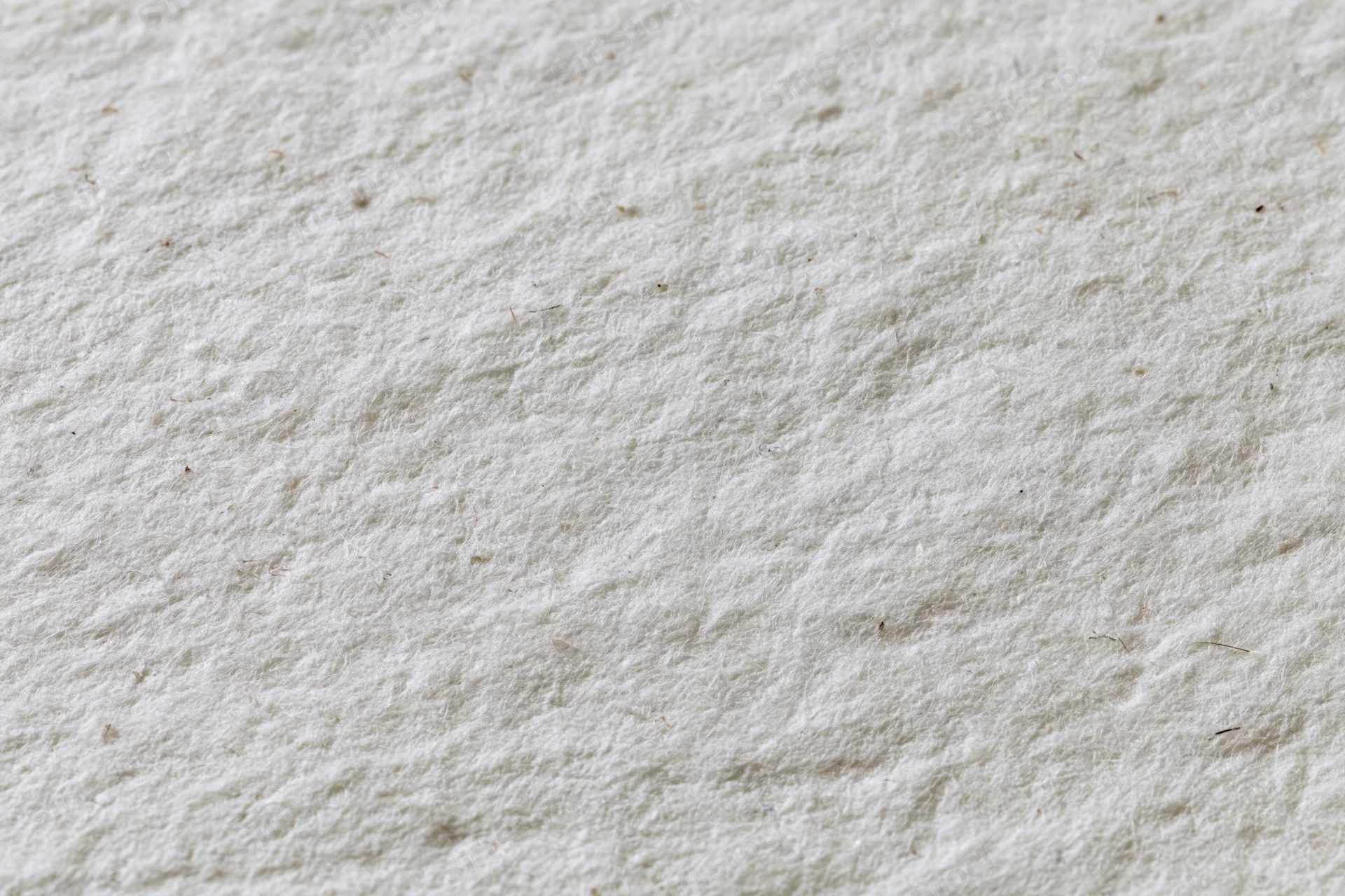 Close-up flat lay of recycled white paper surface filling frame