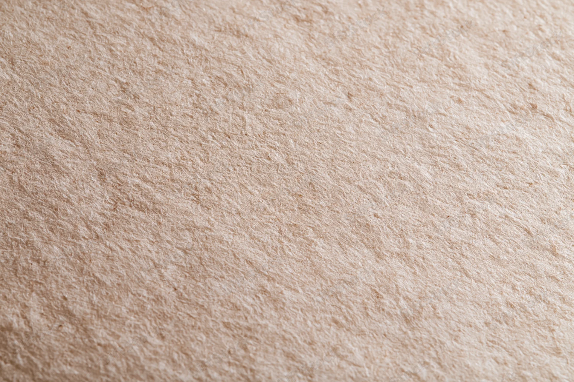 Close-up flat lay of unbleached kraft paper surface filling frame