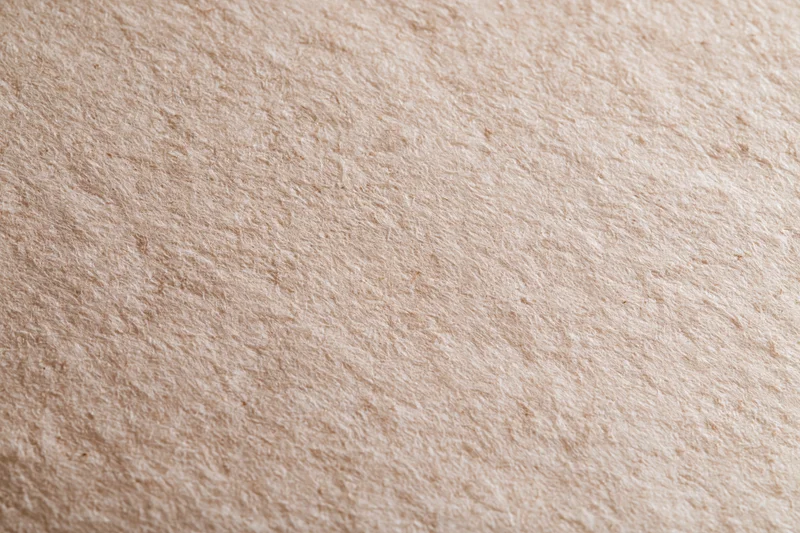 Close-up flat lay of unbleached kraft paper surface filling frame