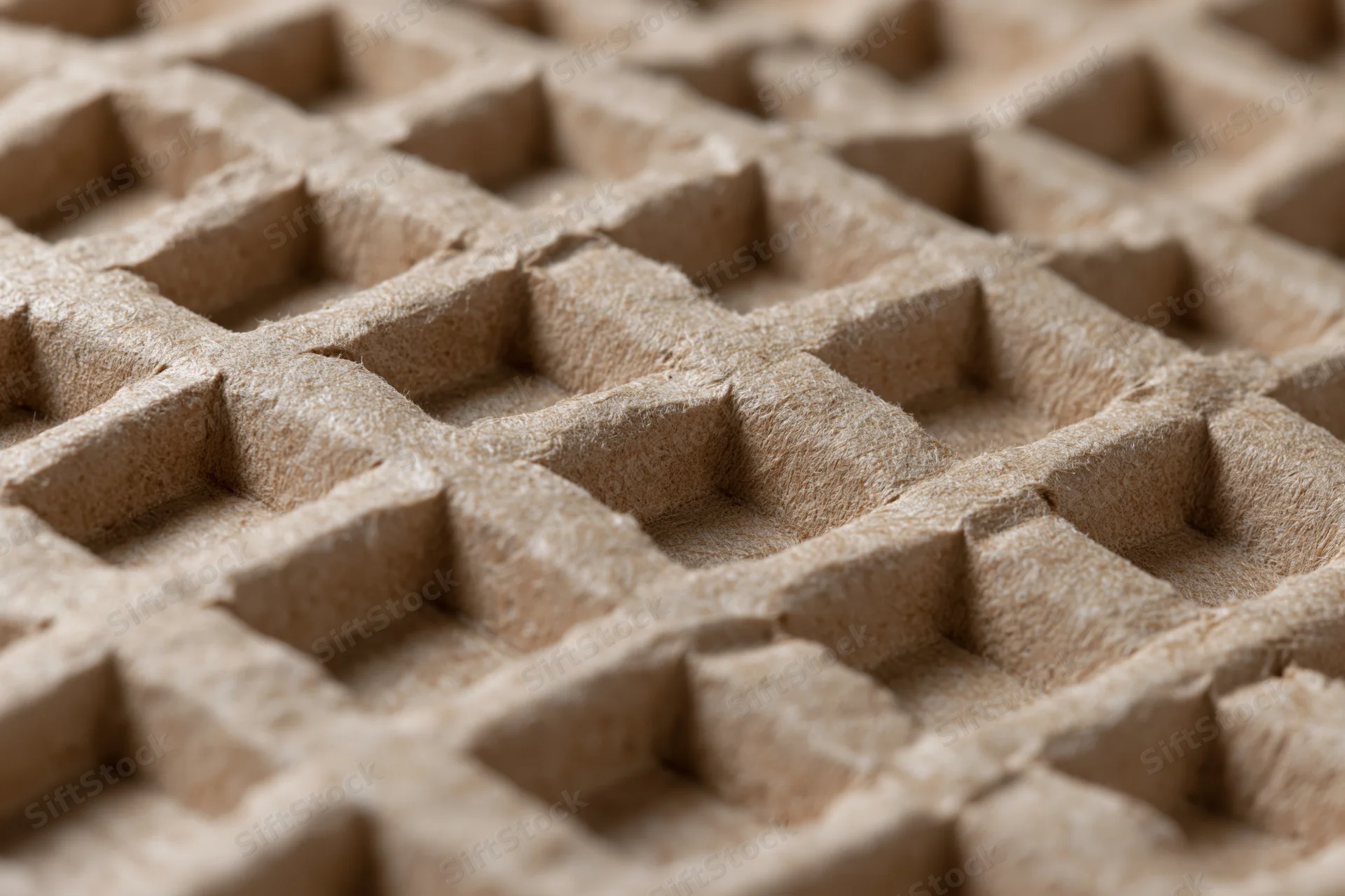 Close-up of textured kraft paper surface with grid pattern for packaging cushioning