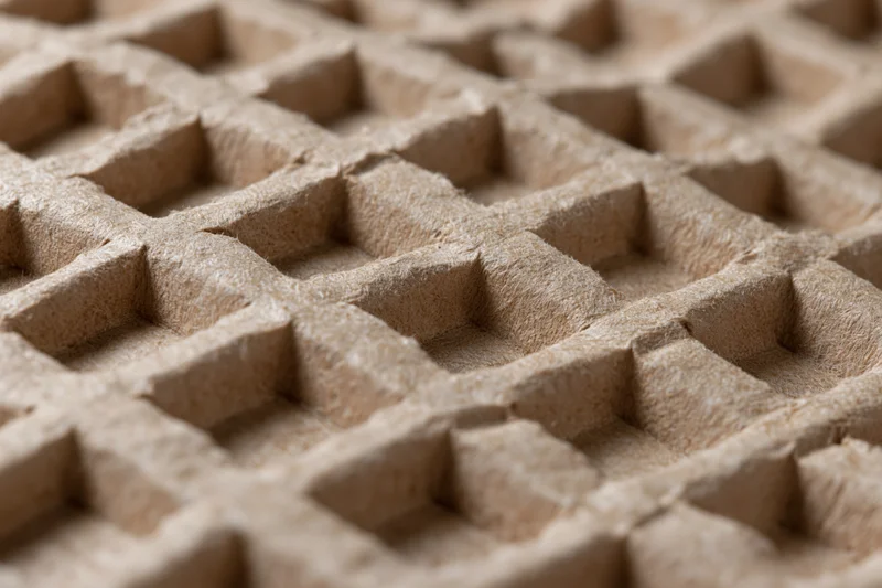 Close-up of textured kraft paper surface with grid pattern for packaging cushioning