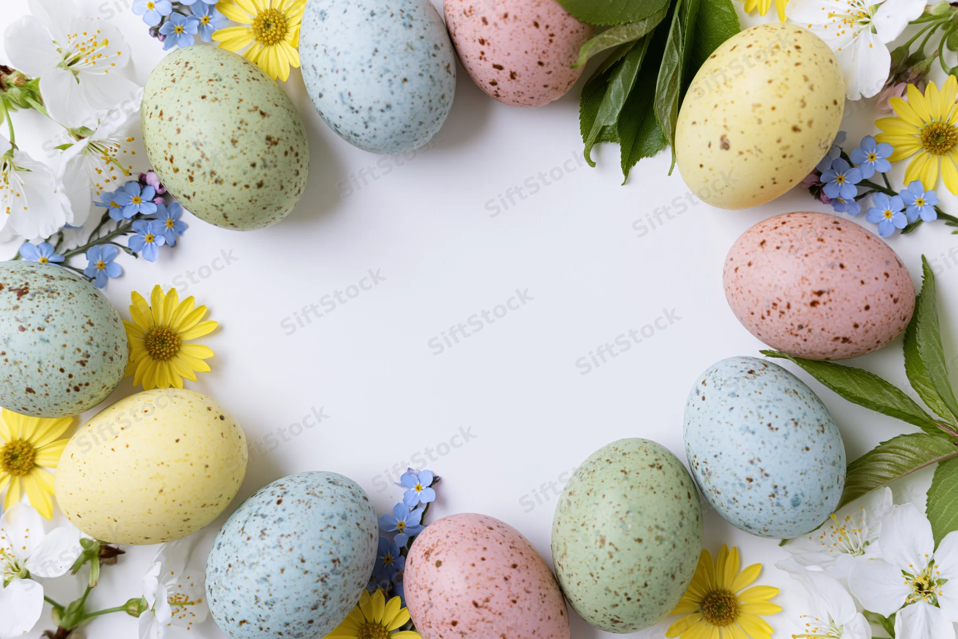 Pastel speckled easter eggs arranged in a floral frame with white and yellow blossoms on a white background