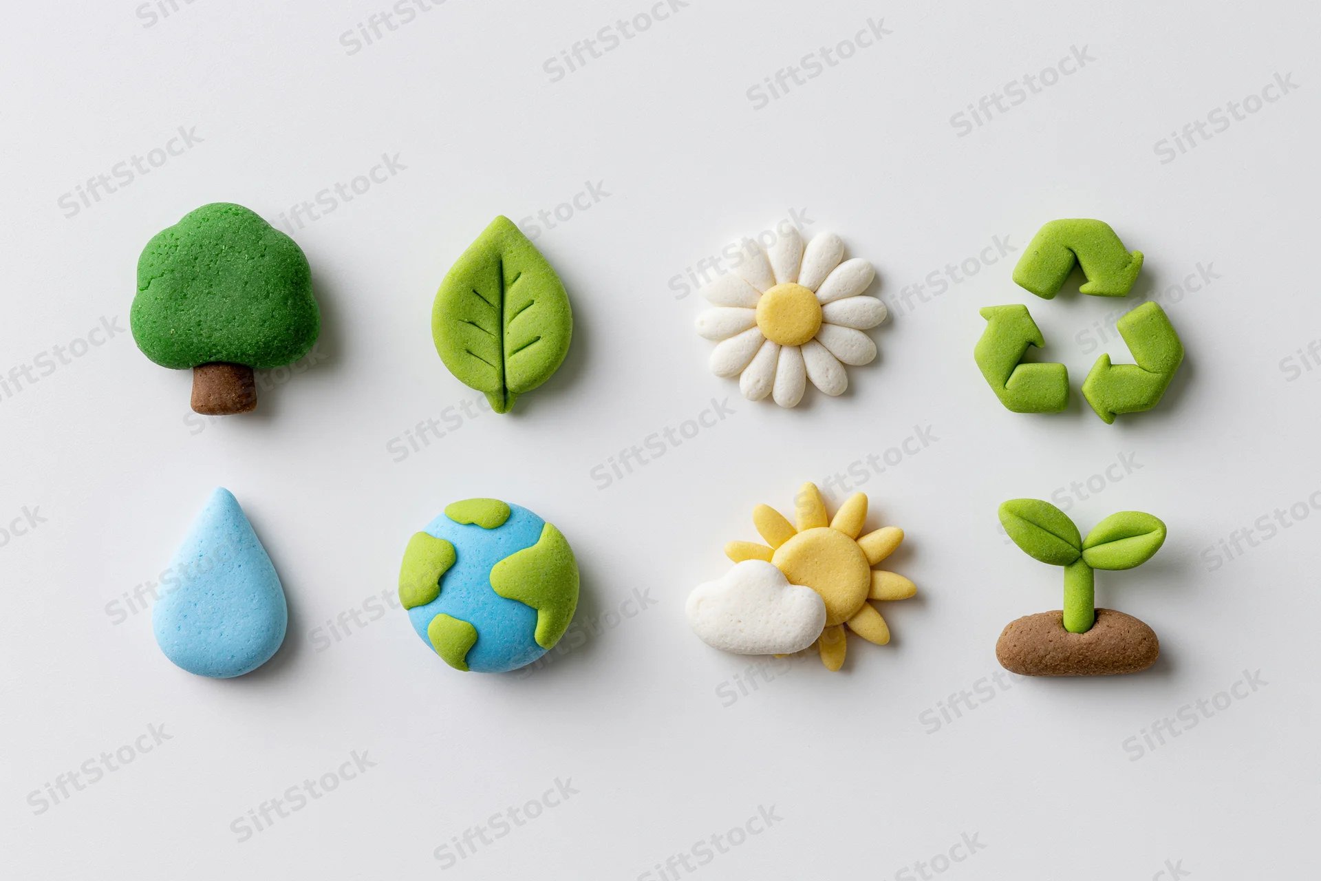 Eight clay-sculpted ecology icons arranged in two rows on white background