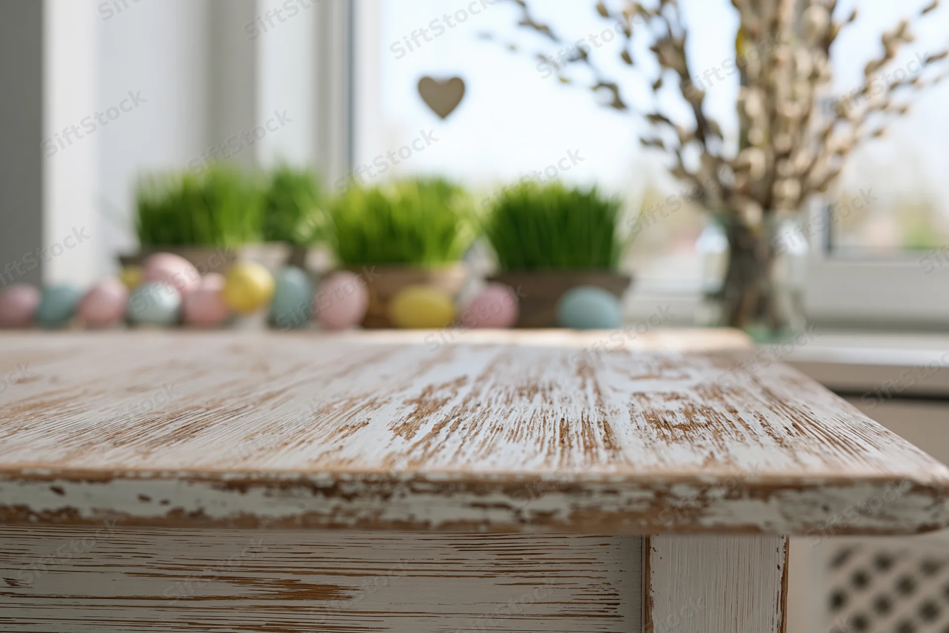 Empty rustic wooden table surface in foreground with easter decorations and spring plants by window