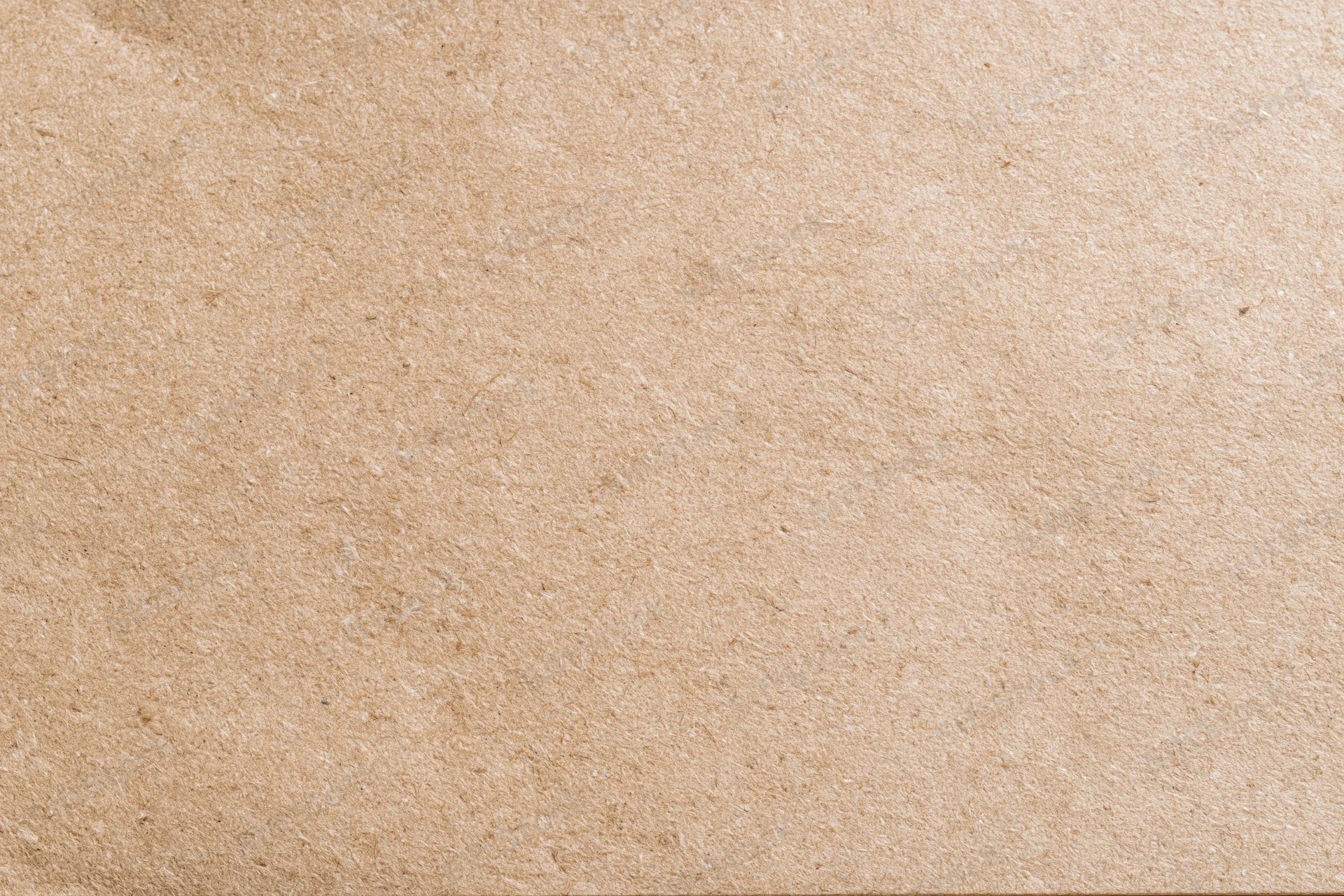 Flat lay close-up of a plain kraft brown paper sheet filling the frame