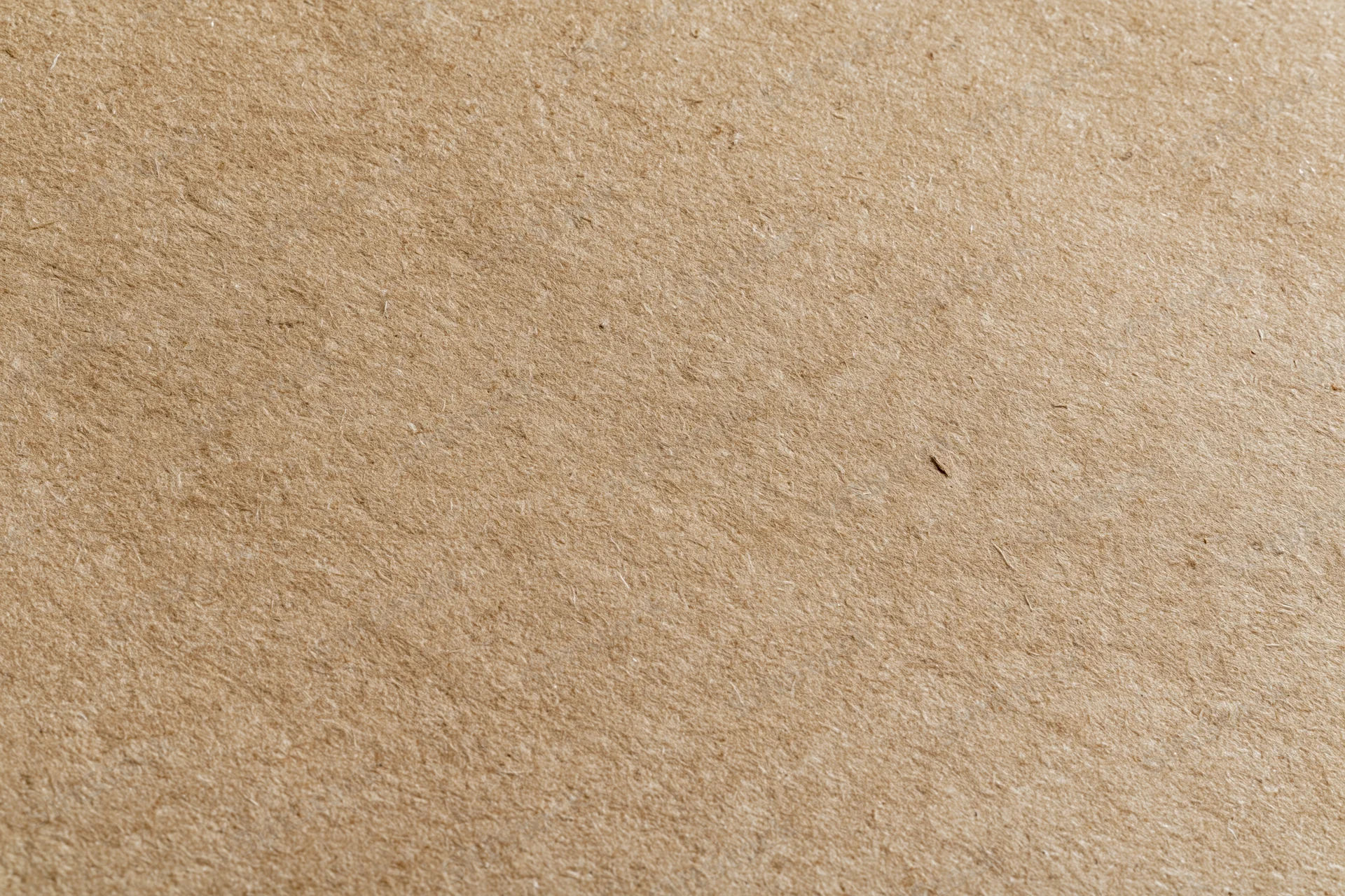 Close-up of a plain kraft brown paper sheet filling the frame