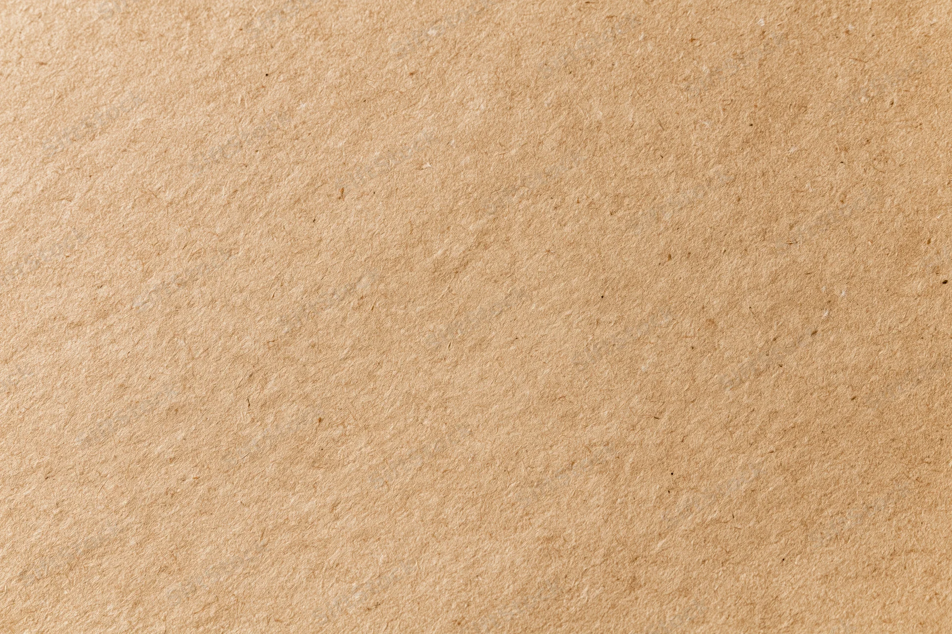 Flat lay close-up of a plain kraft brown paper sheet filling the frame