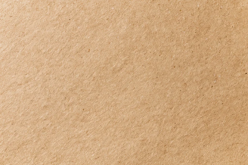 Flat lay close-up of a plain kraft brown paper sheet filling the frame
