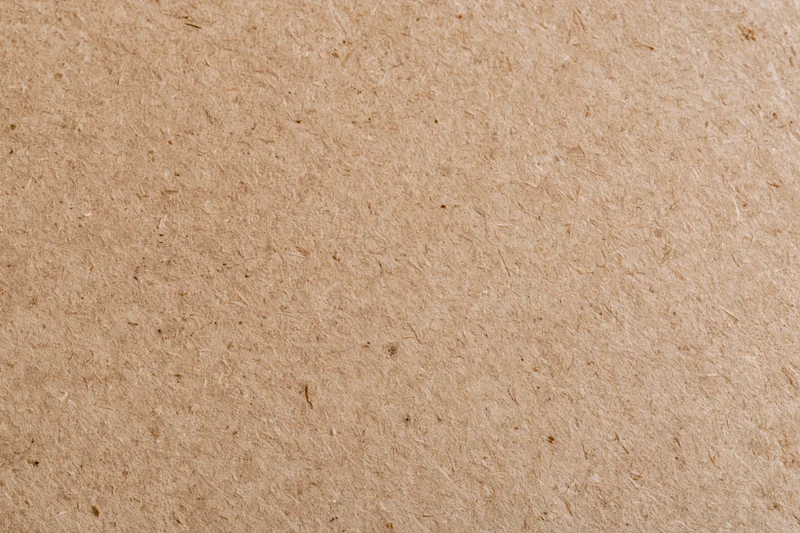 Smooth mdf or hardboard surface filling the frame in a flat lay closeup