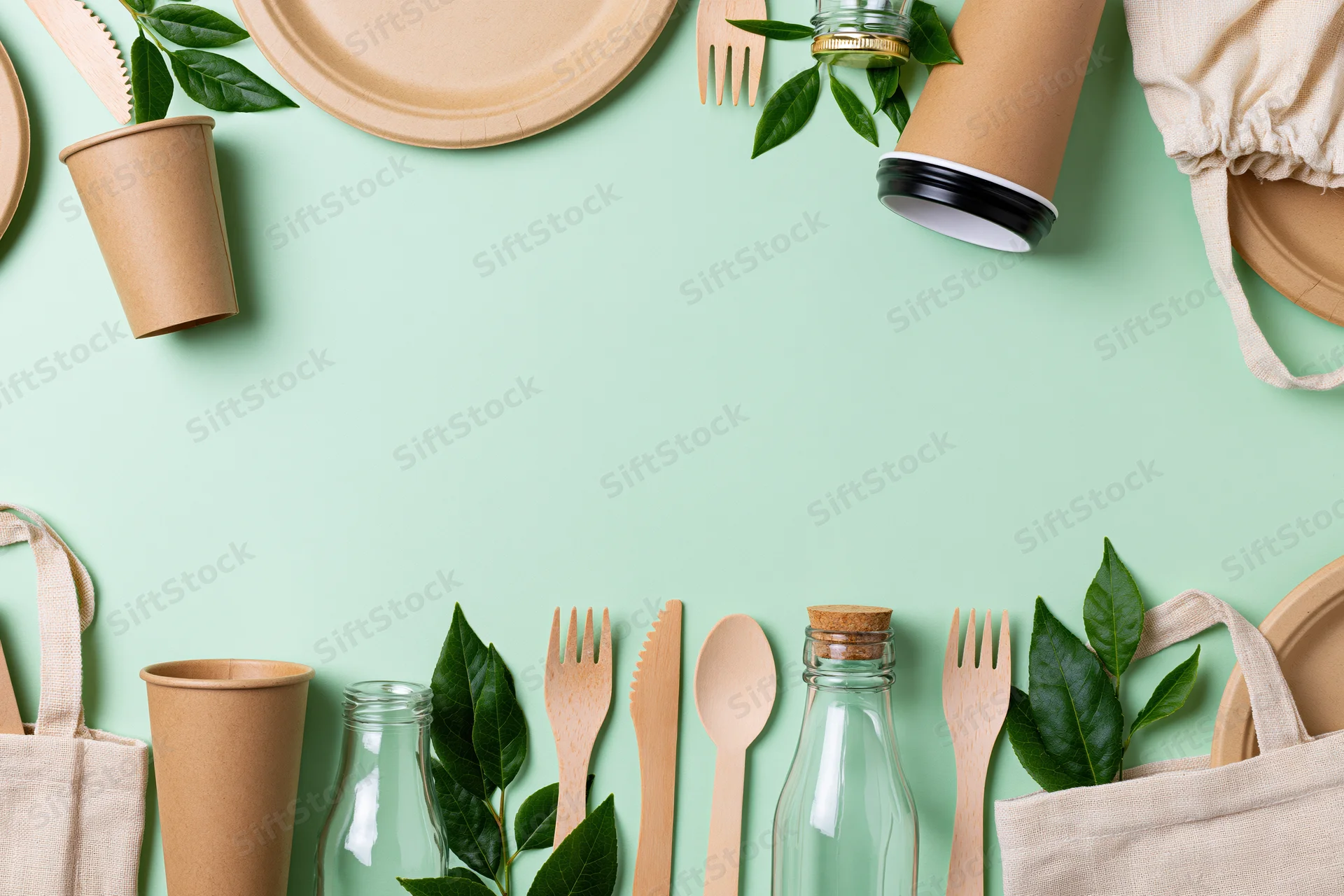 Eco-friendly disposable items arranged in flat lay on mint background with copyspace