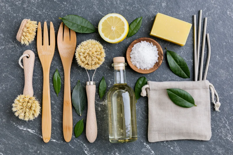 Zero-waste cleaning supplies arranged in flat lay on dark stone surface