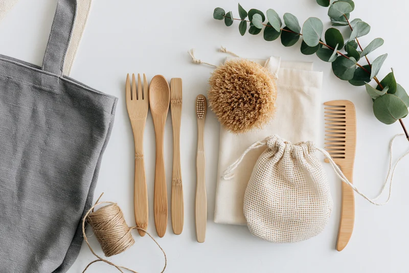 Zero-waste eco-friendly items arranged in flat lay on white surface