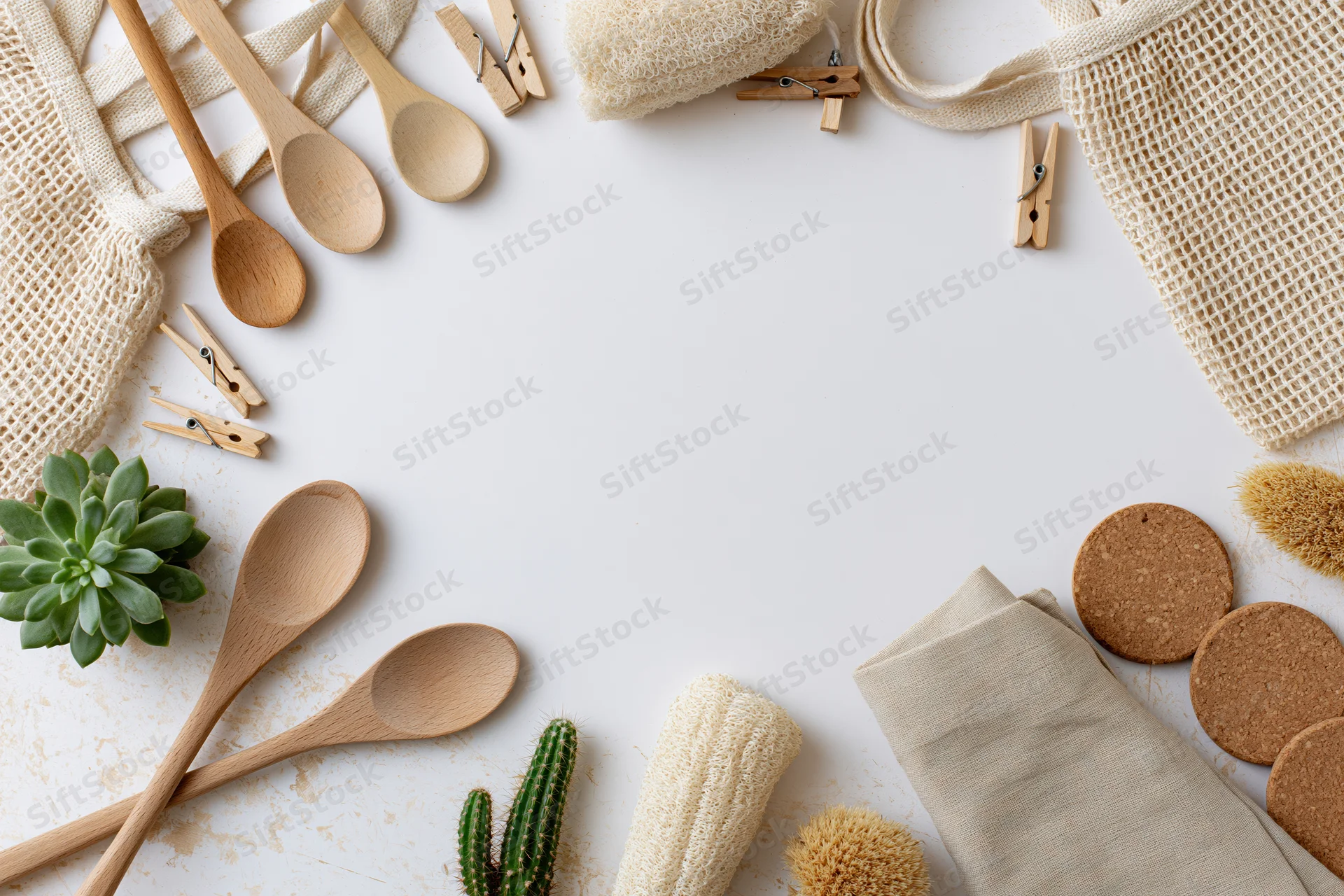Zero-waste household items arranged as a border on a white surface with copyspace