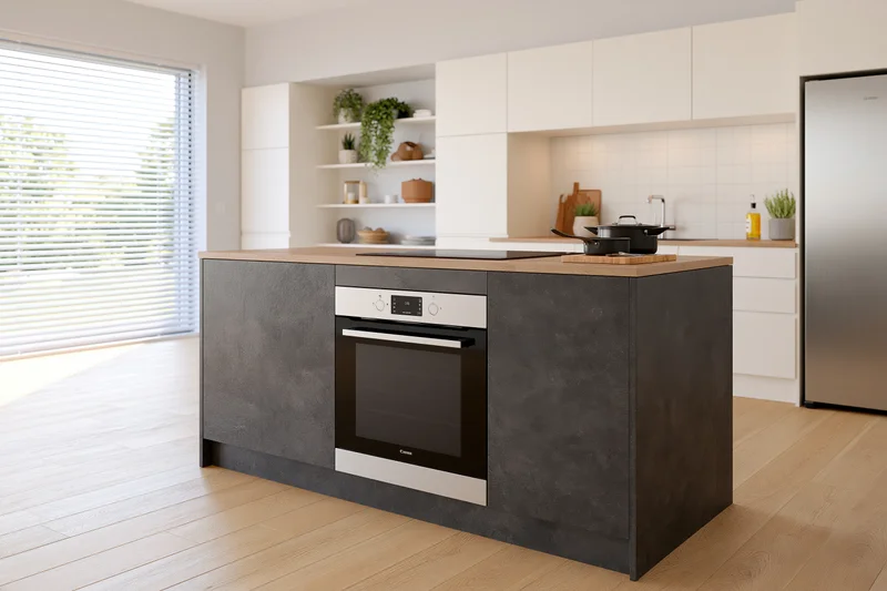 Modern open-plan kitchen with dark stone island and white cabinetry featuring built-in oven and stainless steel refrigerator