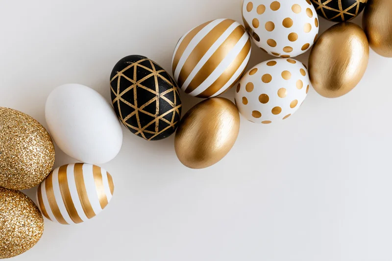 Seven decorated Easter eggs arranged in a diagonal row along a