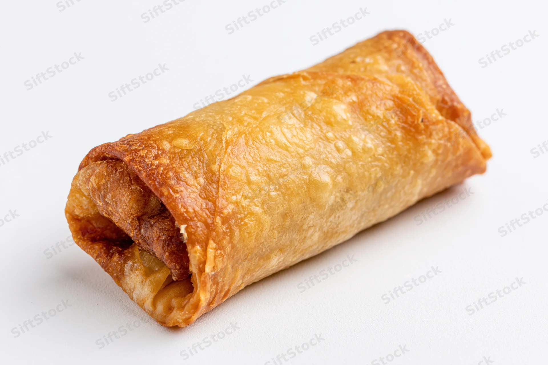 Single fried egg roll resting on a clean white surface isolated