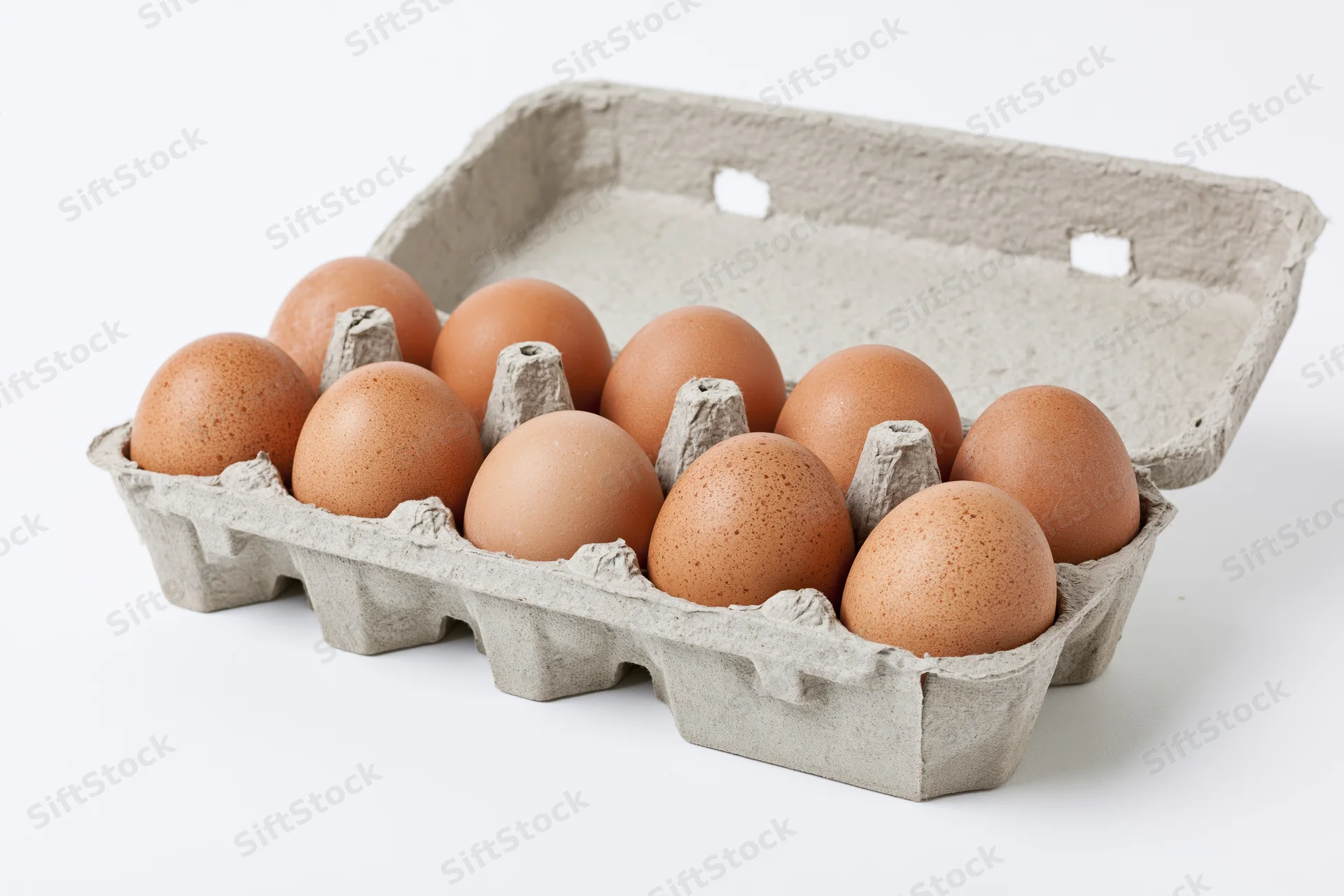 Ten brown eggs arranged in an open gray recycled cardboard egg carton on a white background