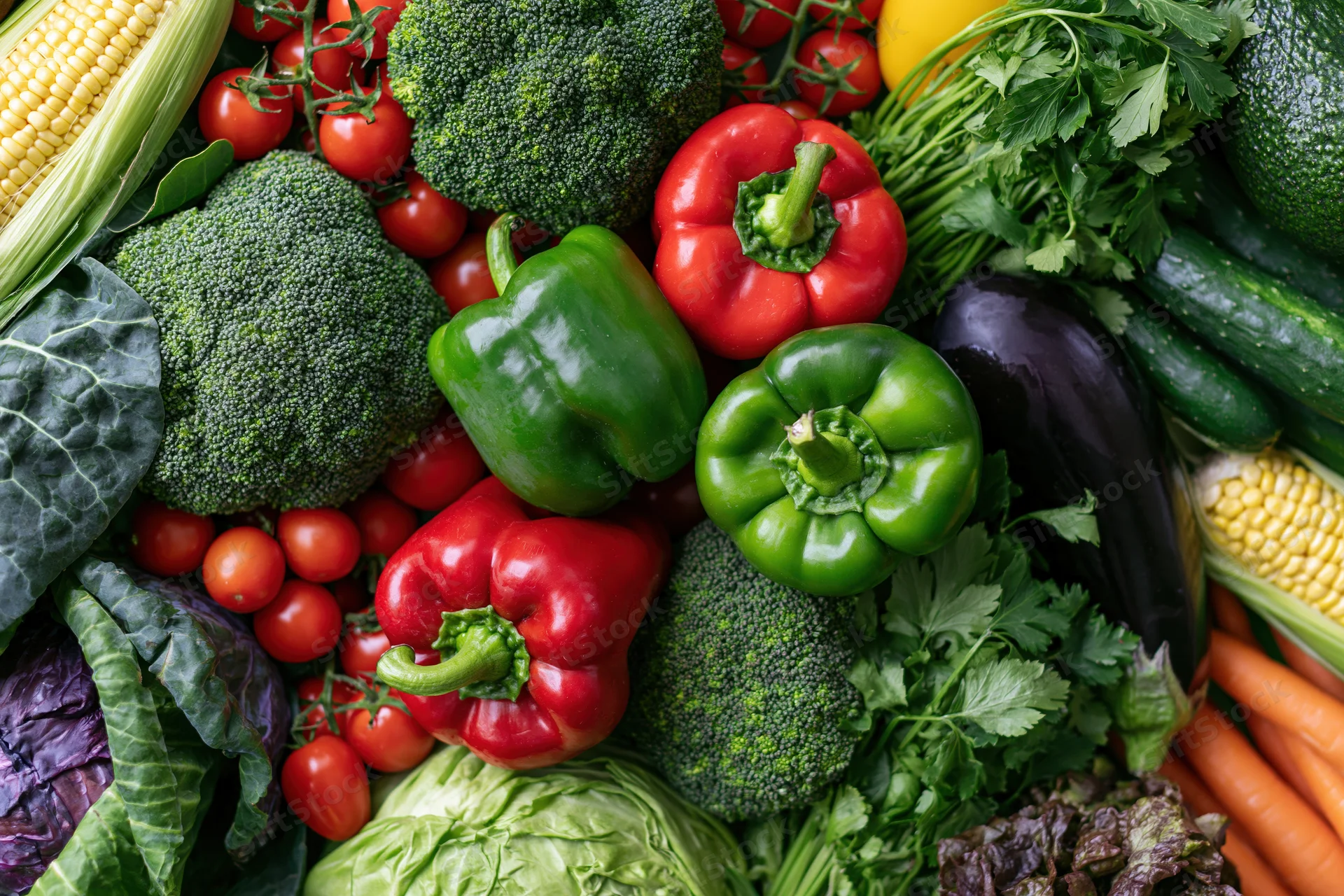 Overhead flat lay of fresh vegetables arranged densely on a surface