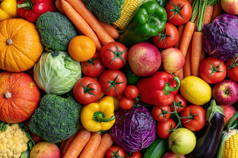 Overhead flat lay of densely packed fresh vegetables and fruits