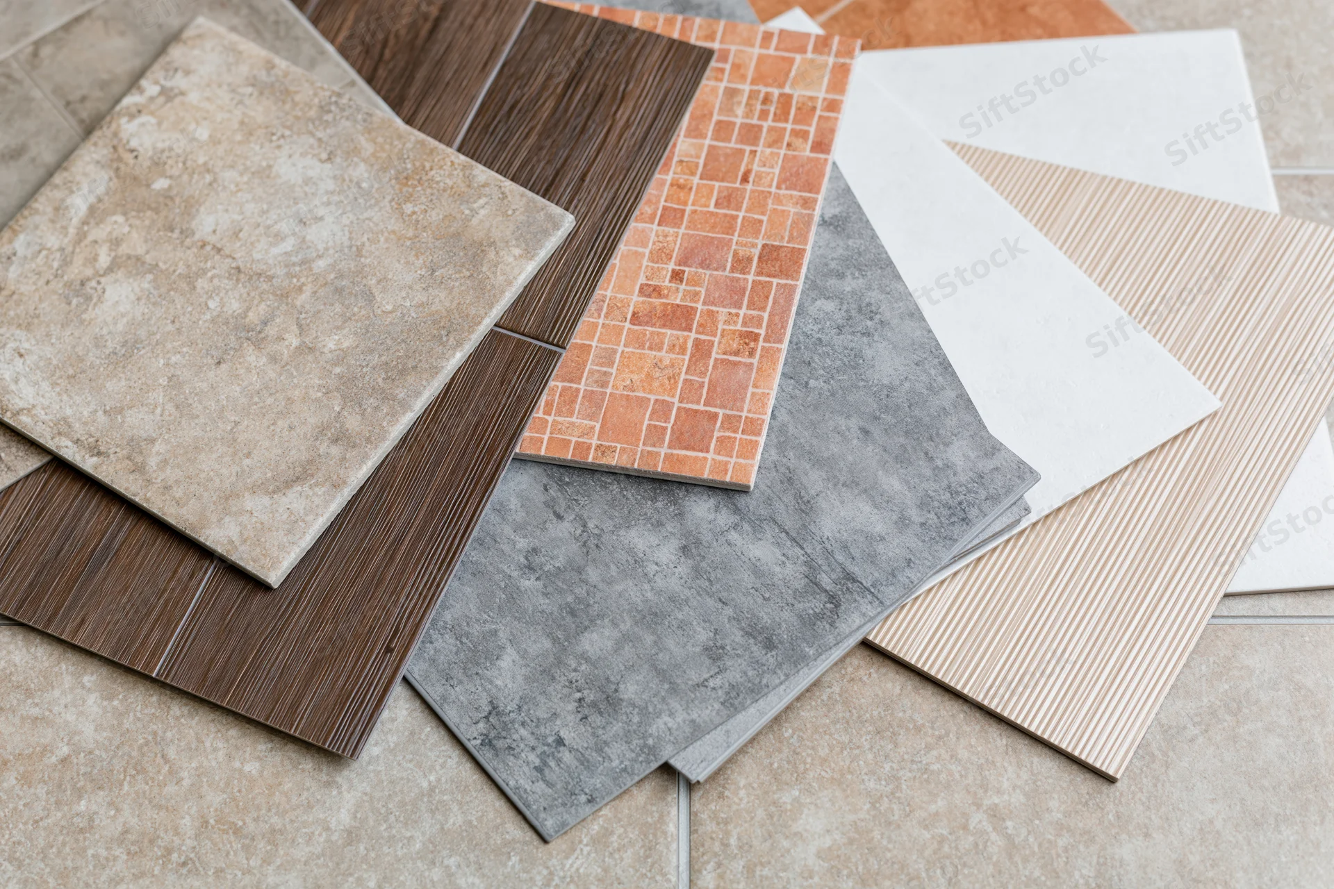 Tile sample squares fanned out on a flooring surface for interior design selection