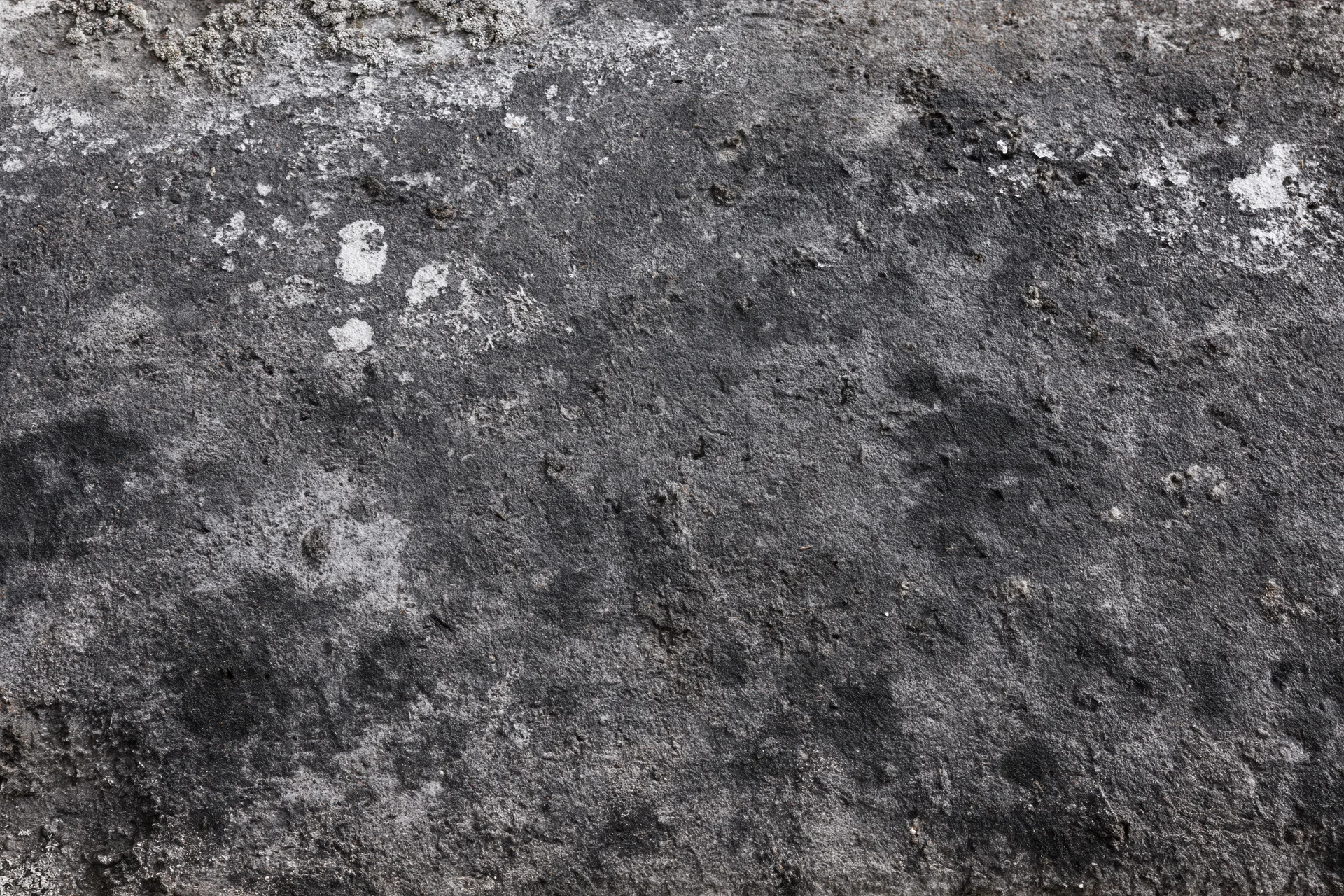 Aged concrete surface with weathered texture and discoloration, flat view filling frame