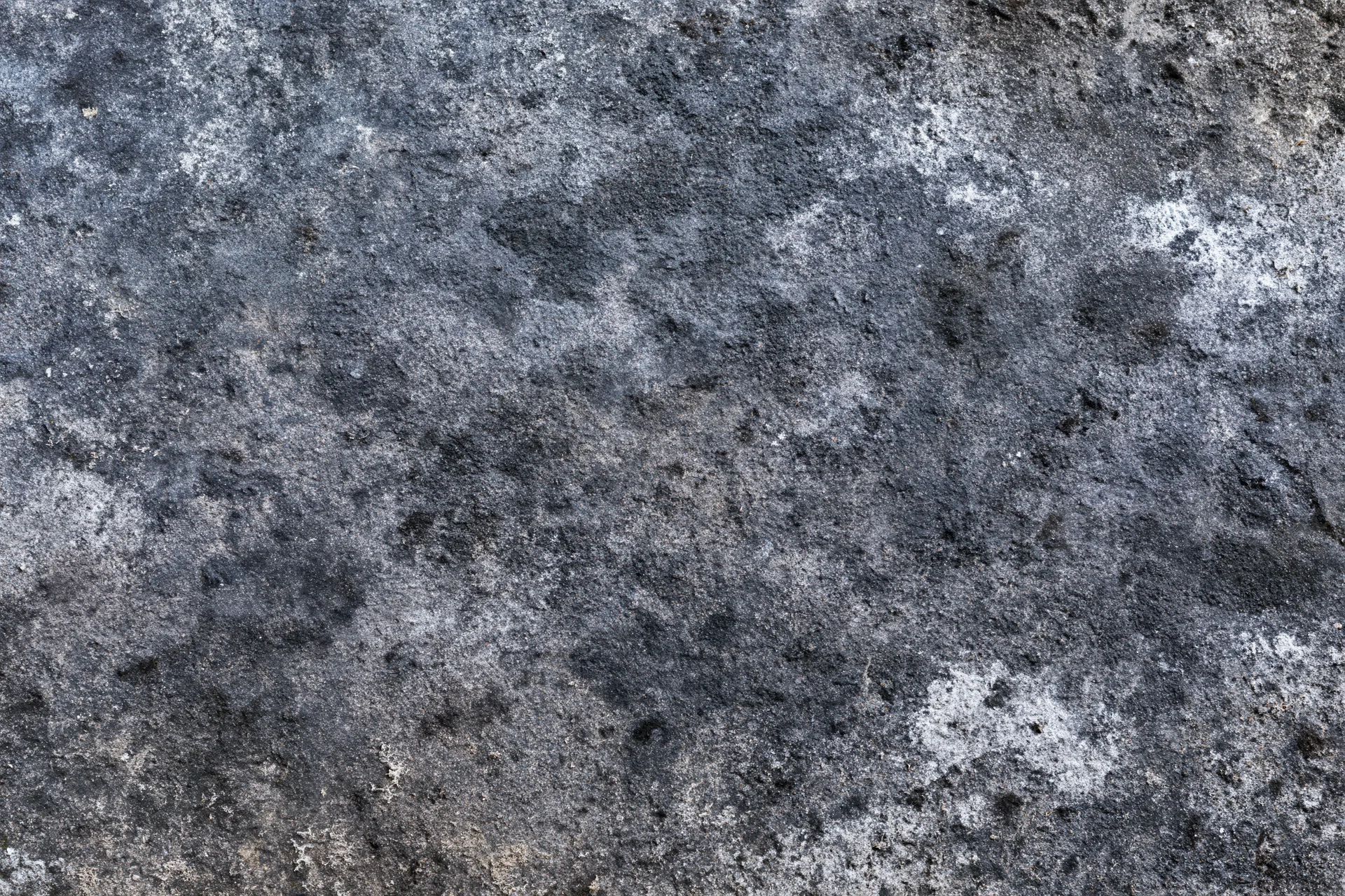 Aged concrete surface photographed flat and straight-on filling the frame