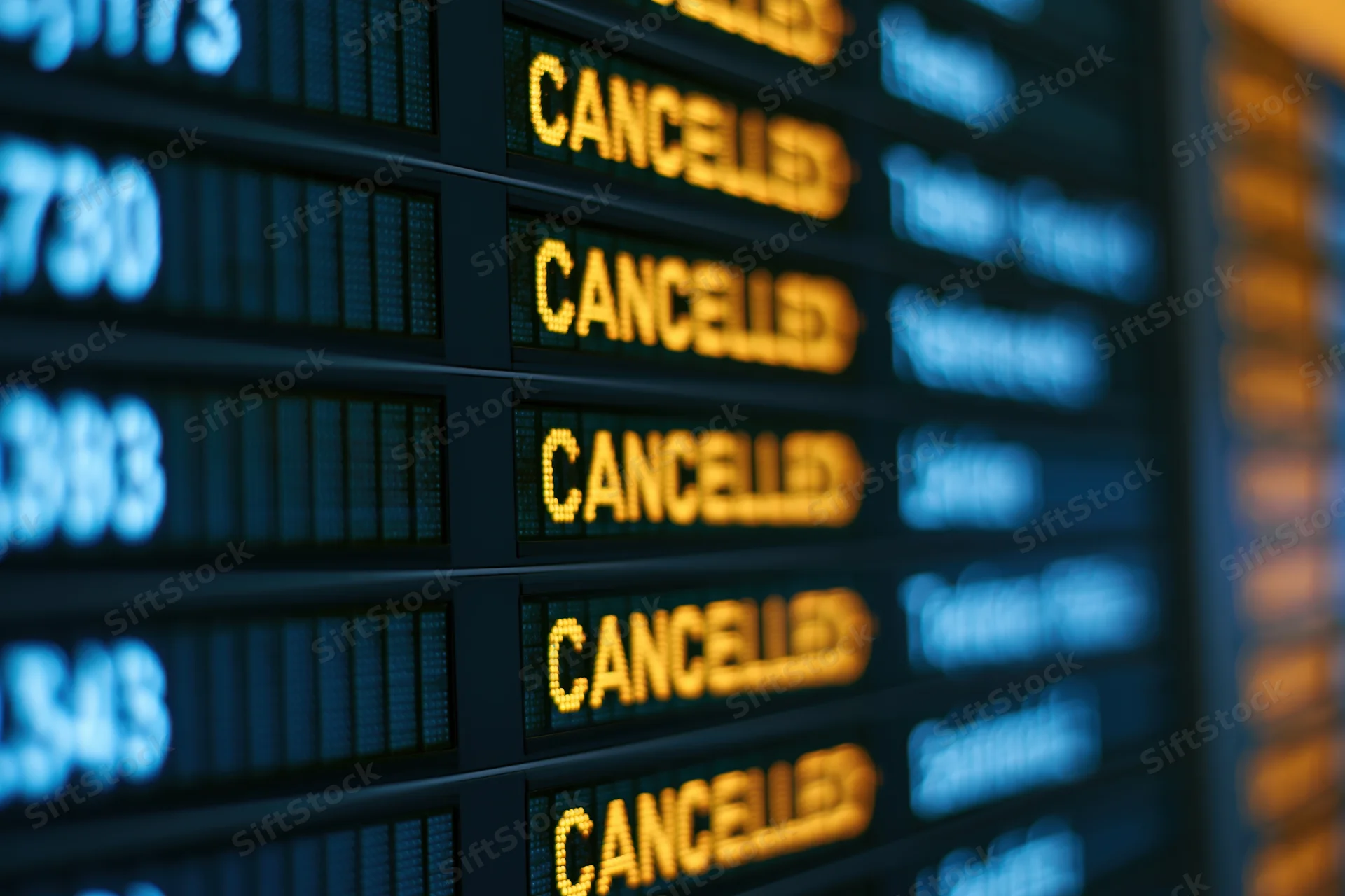 Digital departure board showing multiple cancelled flights in an airport terminal