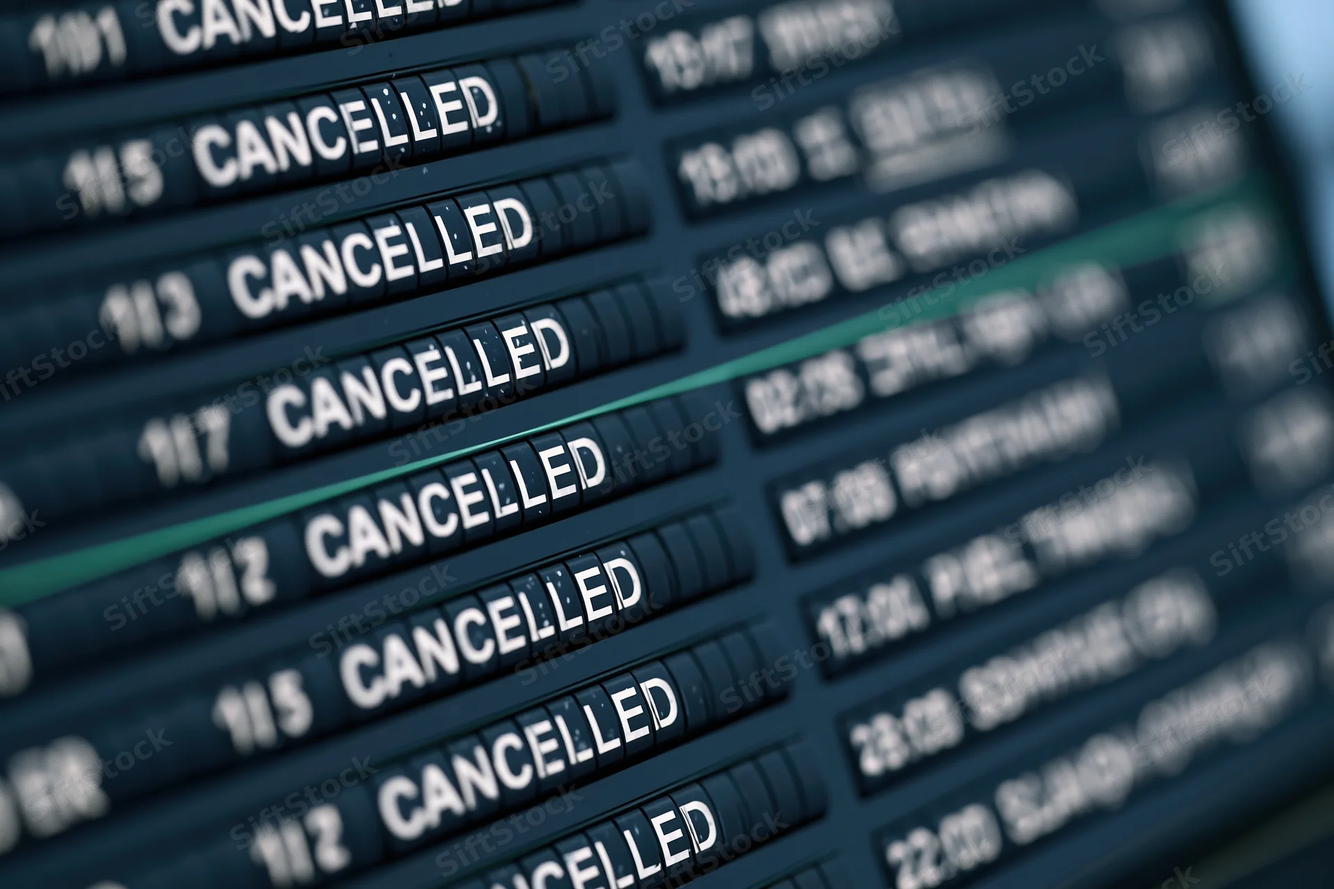Airport departure board showing cancelled flights in rows of text with flight numbers and status updates