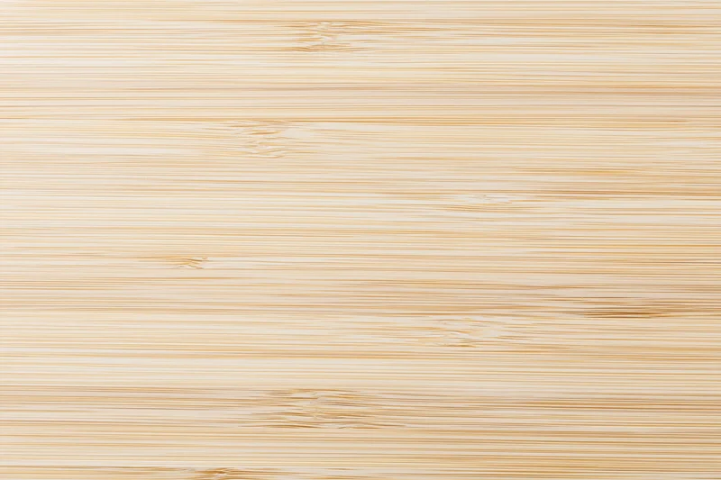 Close-up flat lay of a light bleached bamboo wood surface with horizontal grain pattern