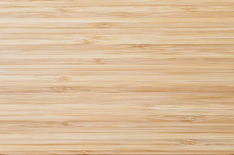 Close-up flat lay of a light bleached bamboo wood surface with horizontal grain pattern