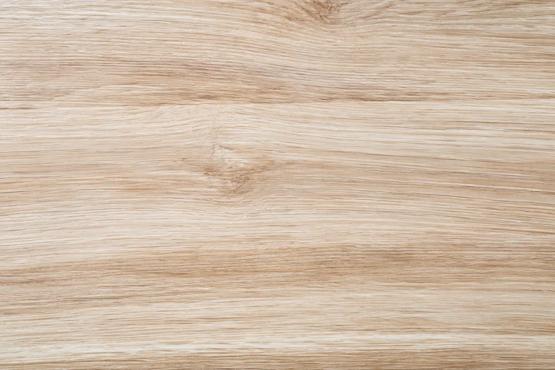 Close-up flat lay of light oak wood surface showing natural grain and texture