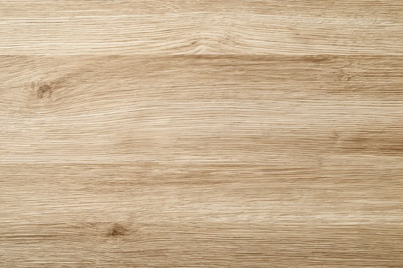 Close-up flat lay of light oak wood surface showing natural grain and texture