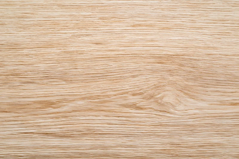 Close-up flat lay of light oak wood surface showing natural grain pattern