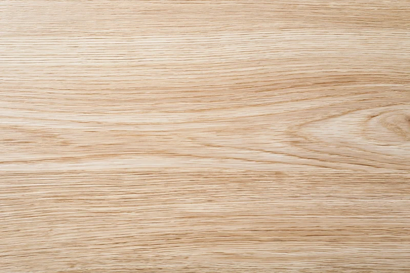 Close-up flat lay of light oak wood surface showing natural grain pattern