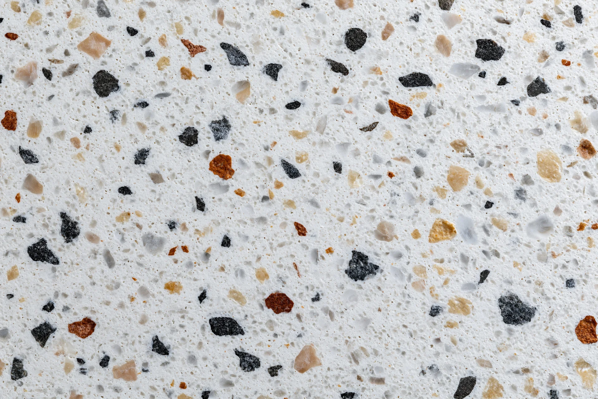 Polished terrazzo floor surface with embedded stone chips in white base