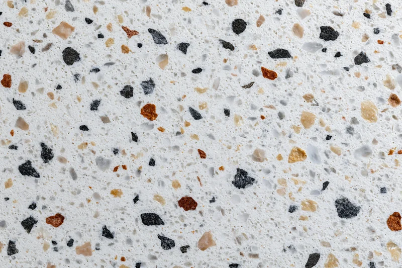 Polished terrazzo floor surface with embedded stone chips in white base