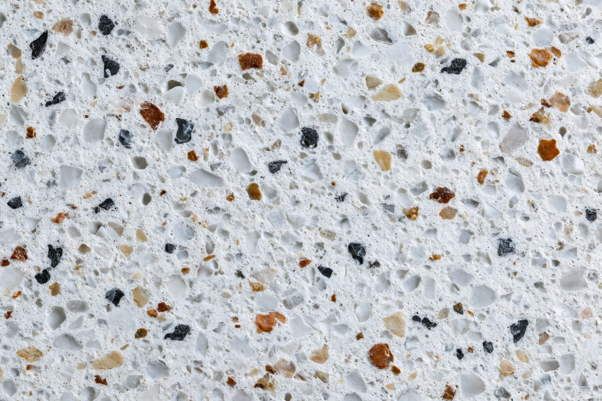 Polished terrazzo floor surface with embedded stone chips in white and gray tones