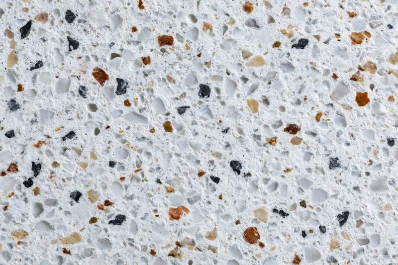 Polished terrazzo floor surface with embedded stone chips in white and gray tones
