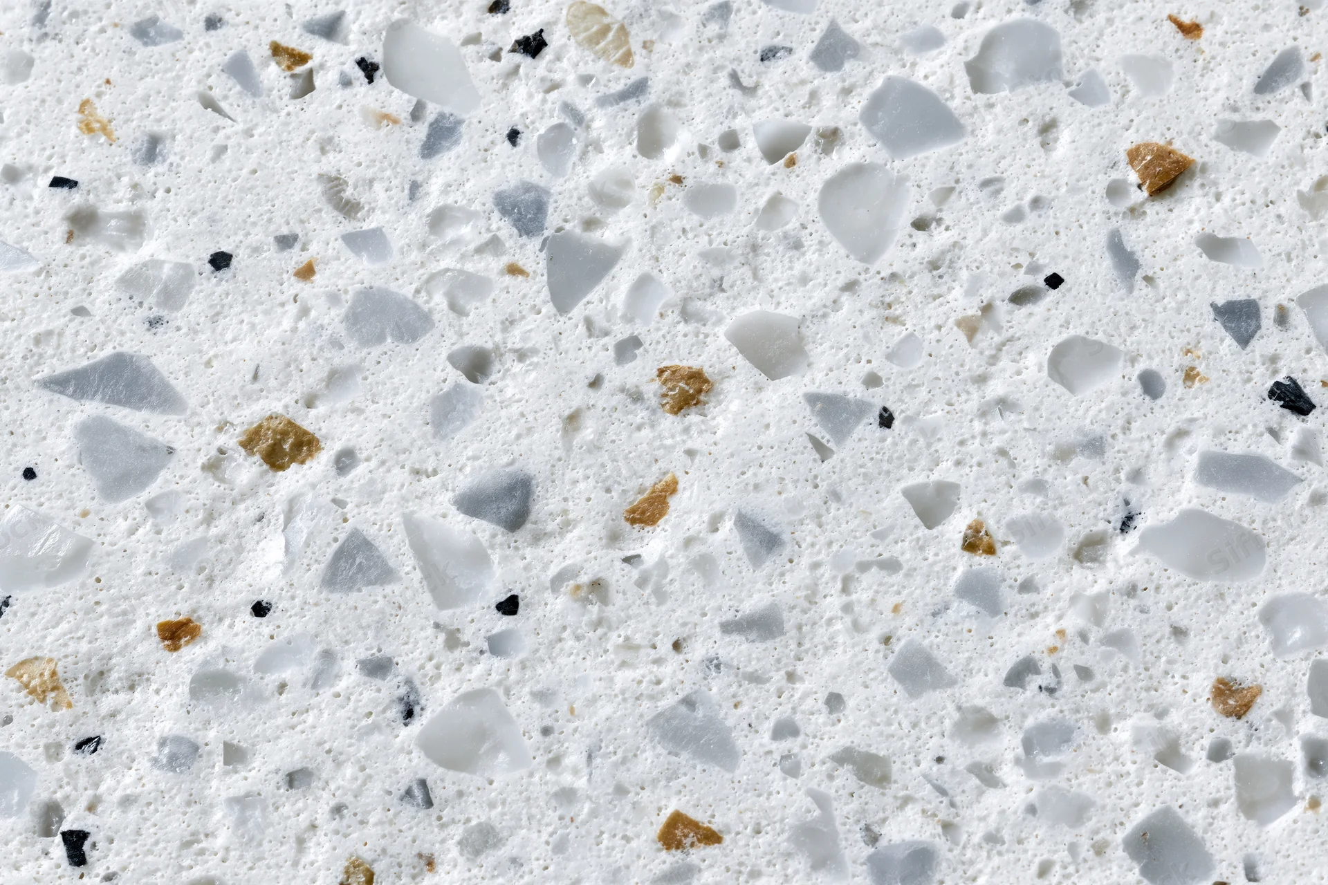 Polished terrazzo surface with embedded stone and glass chips filling the frame