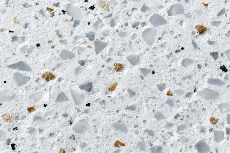 Polished terrazzo surface with embedded stone and glass chips filling the frame
