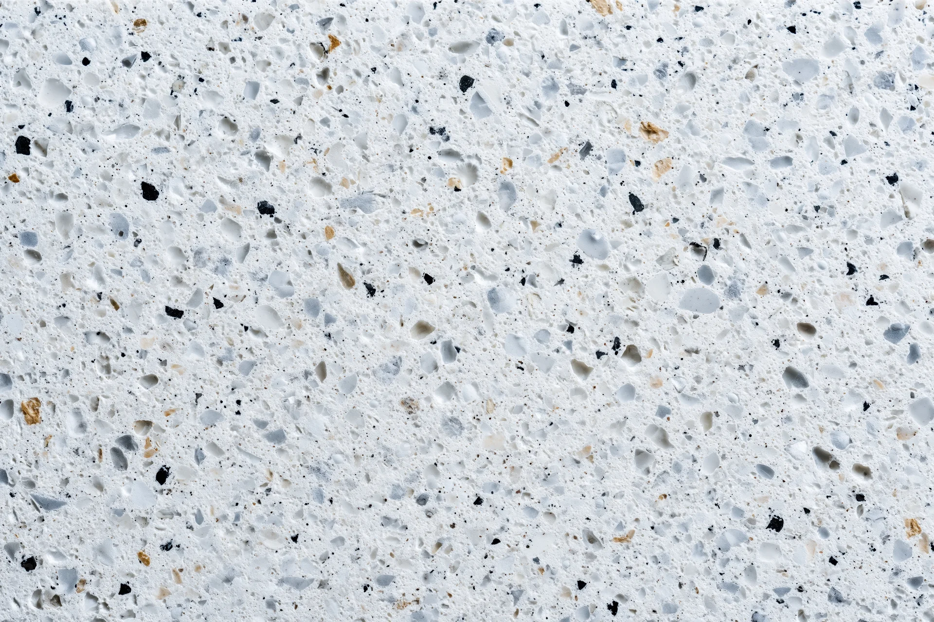 Polished terrazzo surface with embedded stone chips filling the frame