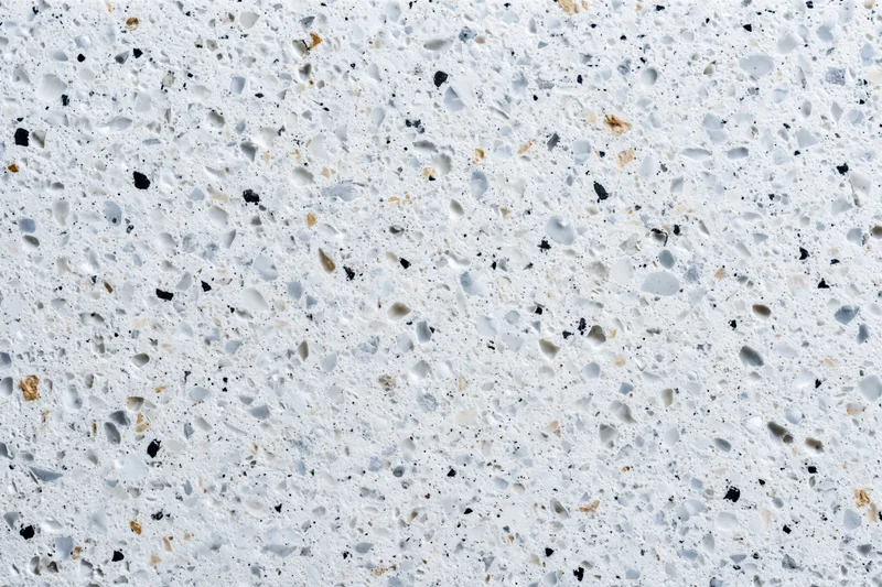 Polished terrazzo surface with embedded stone chips filling the frame