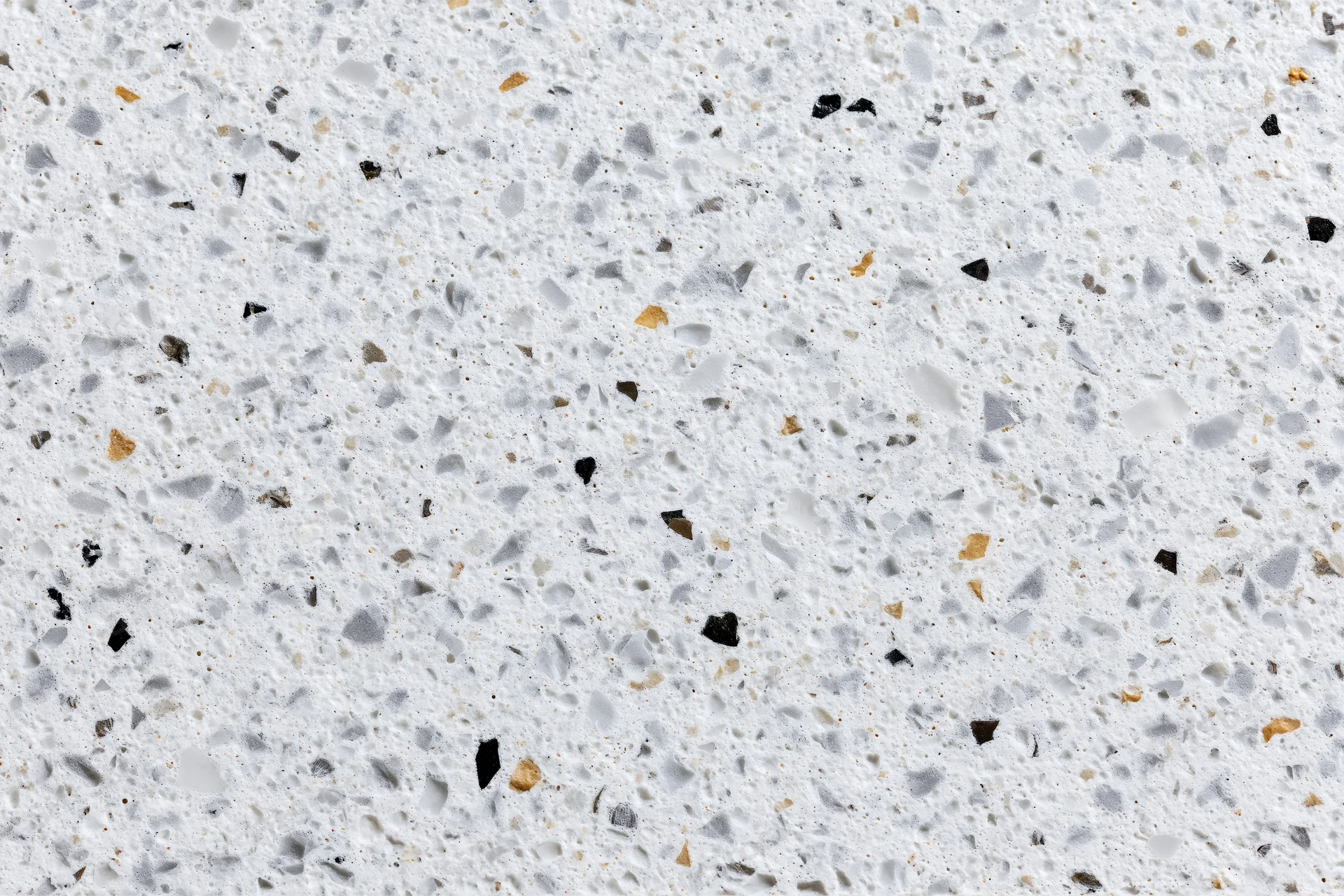 Polished terrazzo surface with embedded stone aggregate filling the frame