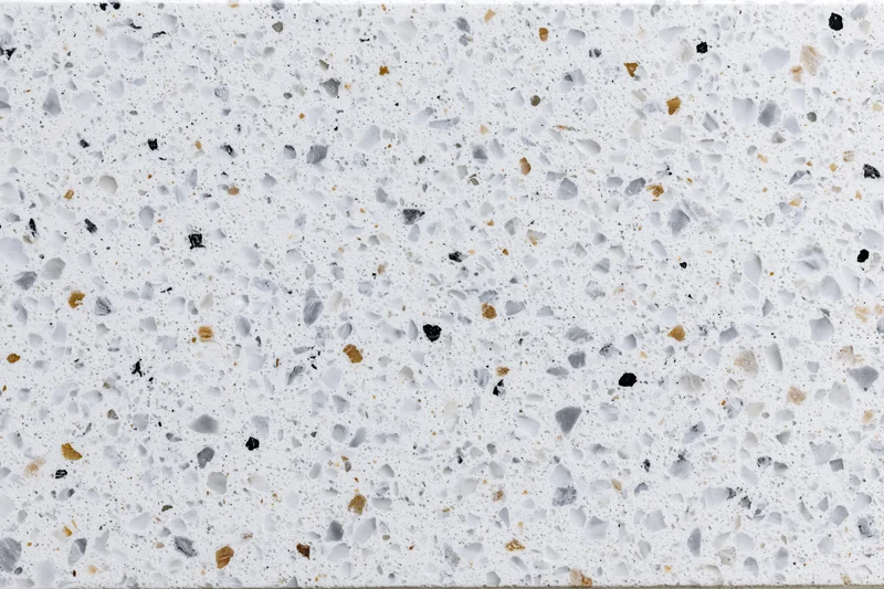 Polished terrazzo surface with white base and multicolored aggregate speckles filling the frame